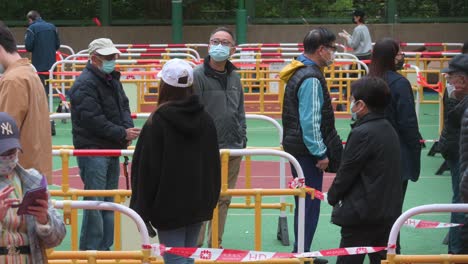Chinese-residents-wait-in-line-to-go-through-a-Covid-19-Coronavirus-testing-as-a-public-housing-complex-is-placed-under-lockdown-after-a-large-number-of-residents-tested-positive