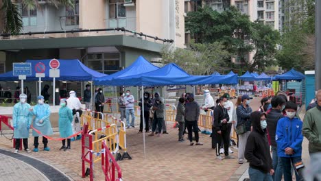 Residents-wait-in-line-to-go-through-a-Covid-19-Coronavirus-testing-as-a-public-housing-complex-is-placed-under-lockdown-after-a-large-number-of-residents-tested-positive