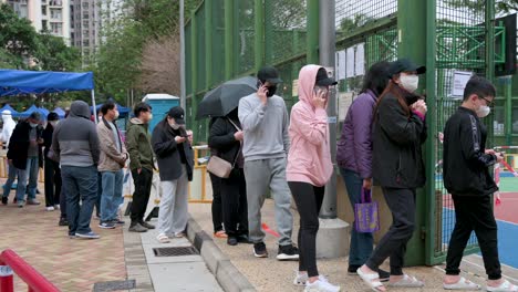 Chinese-residents-go-through-a-Covid-19-coronavirus-mass-screening-testing-outside-a-public-housing-building-placed-under-lockdown-after-a-large-number-of-residents-tested-positive