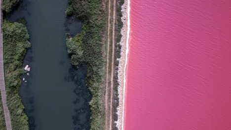 Drone-shot-of-a-river-and-the-pink-ocean-on-the-other-side