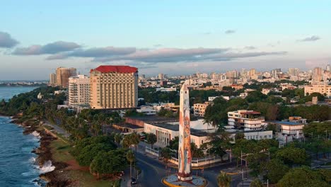 Obelisk-in-Juan-Baron-Plaza-and-amusement-park-along-Malecon-at-sunrise,-Santo-Domingo-in-Dominican-Republic