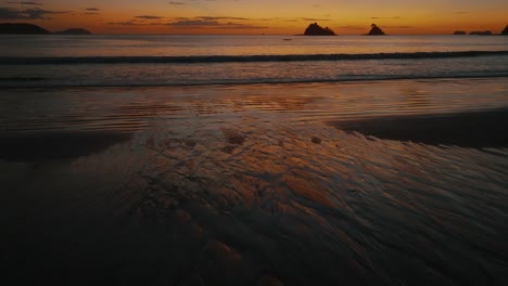 Golden-Sunset-Light-Illuminating-A-Beach-In-Guanacaste,-Costa-Rica---drone-shot