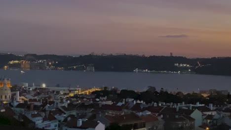 orbit-view-of-Monument-of-the-Discoveries-and-alfama-at-sunset,-Lisbon,-Portugal,-Europe,-4k-aerial-drone-view
