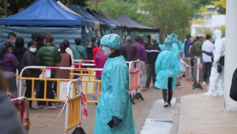 A-health-worker-organizes-residents-to-go-through-Covid-19-Coronavirus-mass-testing-as-a-public-housing-complex-is-placed-under-lockdown-after-a-large-number-of-residents-tested-positive