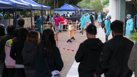 Residents-queue-for-a-Covid-19-Coronavirus-mass-testing-as-a-public-housing-complex-is-placed-under-lockdown-after-a-large-number-of-residents-tested-positive