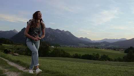 Woman-walks-in-the-mountains-while-its-blue-hour-in-Momjeans-on-a-small-path