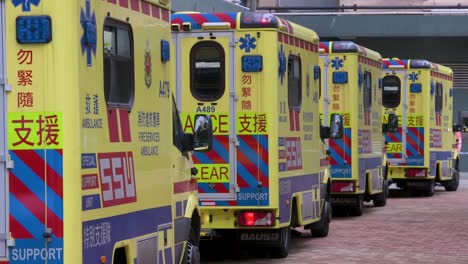 A-row-of-ambulances-are-seen-parked-outside-a-building-placed-under-Covid-19-Coronavirus-lockdown-at-a-public-housing-complex-after-a-large-number-of-residents-tested-positive