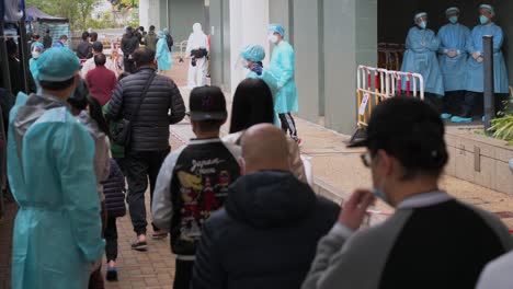Chinese-residents-queue-in-line-to-go-through-a-Covid-19-Coronavirus-testing-as-a-public-housing-complex-is-placed-under-lockdown-after-a-large-number-of-residents-tested-positive