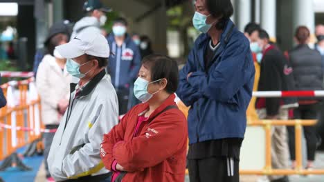 Chinese-residents-wait-in-line-to-go-through-a-Covid-19-Coronavirus-testing-as-a-public-housing-complex-is-placed-under-lockdown-after-a-large-number-of-residents-tested-positive