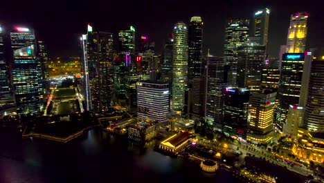 Panorama-of-Singapore-Central-Banking-District-at-night,-slow-drone-orbit