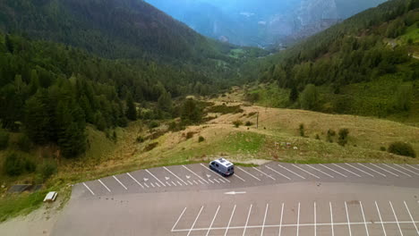 Drone-Shot:-Campervan-stands-at-a-parking-lot-in-the-mountains-with-a-great-view-on-the-mountains