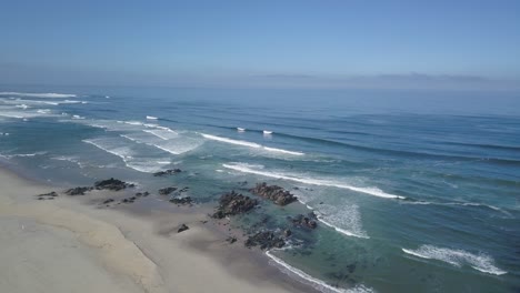 Aerial-view-of-surfers-on-the-sea-waiting-for-the-wave