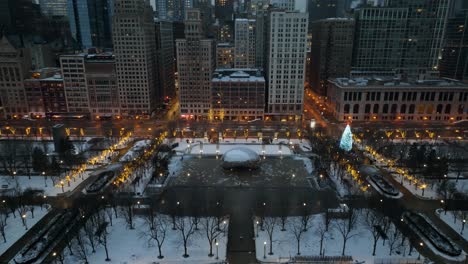 Aerial-view-approaching-the-Cloud-Gate,-surrounded-by-Christmas-decorations,-gloomy,-winter-evening-in-Chicago,-USA