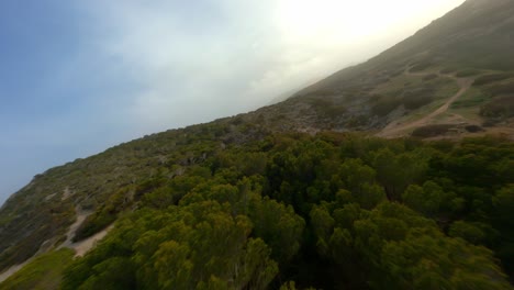 FPV-Drone-flying-low-across-Mallorca-hills-and-diving-down-hills
