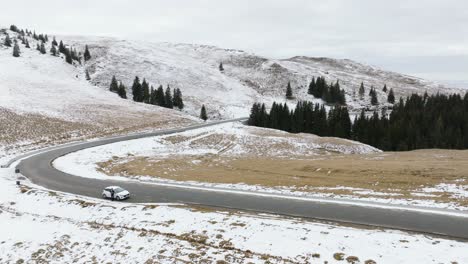 snowy-scene-Of-mountain-Road-Near-Green-Virgin-Forest-In-Bucegi-Mountains,-Romania