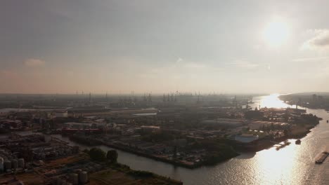 Hamburg-Harbour-during-late-evening-sun-with-harbour-cranes-and-Queen-Mary-2-in-the-background
