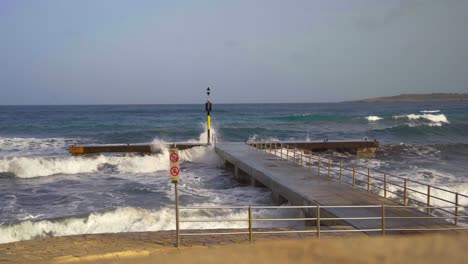 Ocean-waves-breaking-at-a-stone-peer-on-Mallorca-with-big-splashes