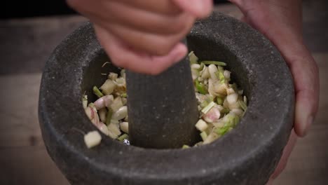 Garlic-Herbs-and-Chilly-Making-Curry-Paste-from-Scratch-with-Mortar-and-Pestle,-Stone-Mortar-Making-Fresh-Paste-by-Hand