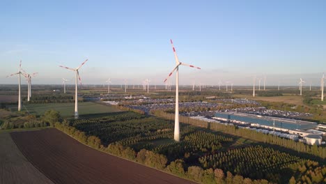Majestic-aerial-view-flight-panorama-overview-drone
of-a-Wind-farm-wheel-Field-Next-to-industrial-park-at-Brandenburg-Germany-at-summer-day-2022