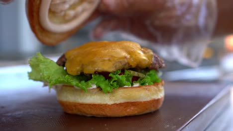 Putting-a-bun-on-a-cheeseburger--close-up
