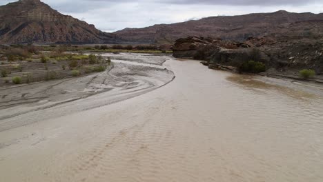 Low-flying-drone-shot-flood-in-a-desert,-Utah,-USA