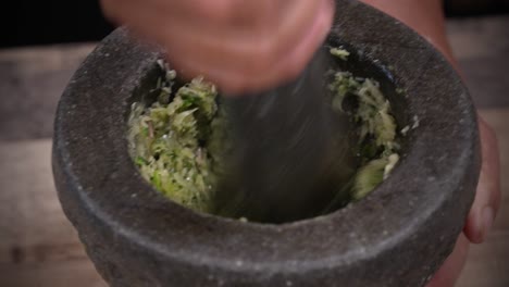 Pounding-Fresh-Ingredients-with-Stone-Mortar-and-Pestle,-Fresh-Paste-Cooking-Close-Up