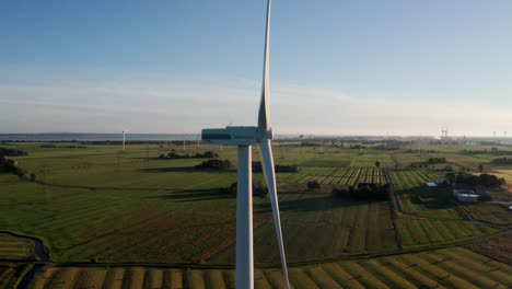 Drone-Shot-wind-turbine-close-up-of-wing-in-the-sun-set-during-golden-hour
