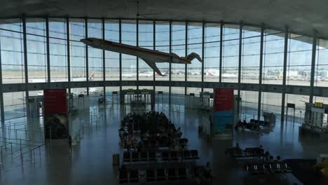 Wide-shot-of-Valencia-airport-Hall-with-plane-decoration-hanging-from-ceiling,-Spain