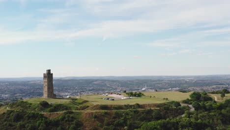 drone-shot-of-Castle-hill-aka-Victoria-tower-in-Huddersfield-with-the-town-in-the-background-on-the-right