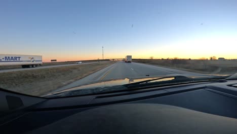 POV-while-driving-on-Interstate-at-sunset-in-rural-Midwest