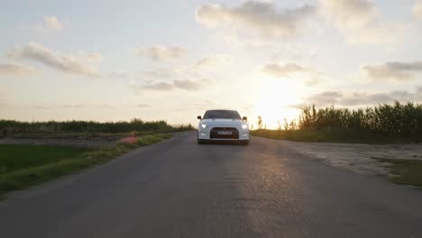 White-Nissan-GTR-sports-car-drive-countryside-road