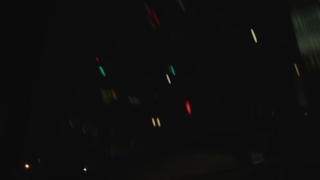 Pov-of-passenger-side-window-driving-through-Los-Angeles,-CA---at-night