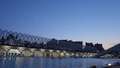 Summer-evening-at-The-City-of-Arts-and-Sciences,-paddleboarding-in-Valencia,-Spain