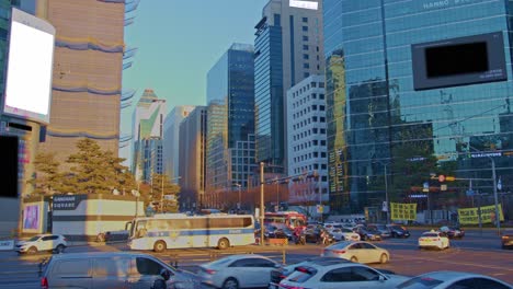 Big-city-life-wide-angle-view-of-town-in-South-Korea,-Seoul,-Gangnam-traffic-with-cars,-buses,-skyscrapers-and-big-urban-architecture