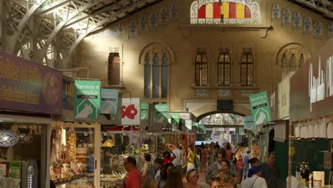 Wide-angle-shot-of-people-shopping-inside-beautiful-Central-Valencia-Marketplace,-Spain