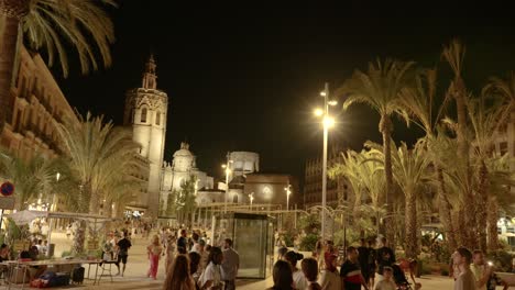 Main-Valencia-Reina-square-in-historic-old-town,-full-of-tourists-at-summer-night,-Spain