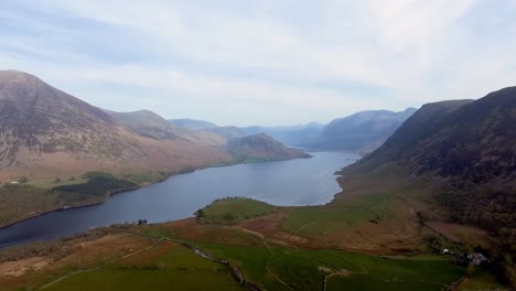 Drone-flying-over-lake-and-between-mountains-in-the-lake-district-in-England