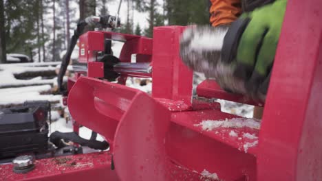 Man-Is-Cutting-Frozen-Conifer-Woods-Using-Log-Splitter-Machine