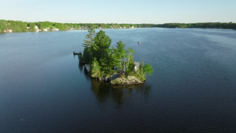 an-Island-with-a-cottage-in-Muskoka-region,-Ontario,-Canada,-Drone-orbit