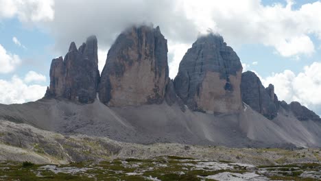 Aerial-View-Looking-At-Tre-Cime-Di-Lavaredo-With-Clouds-Over-The-Peaks