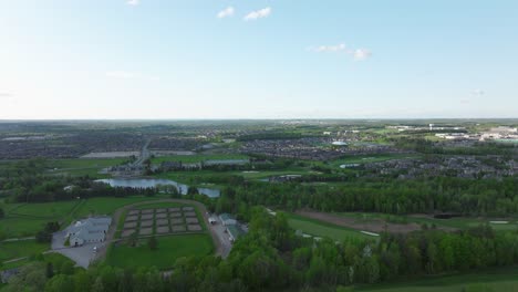Golf-pitch-in-Aurora,-Ontario,-Canada-in-may,-panorama-on-the-city-from-a-drone,-Drone-flying-backwards-part-2
