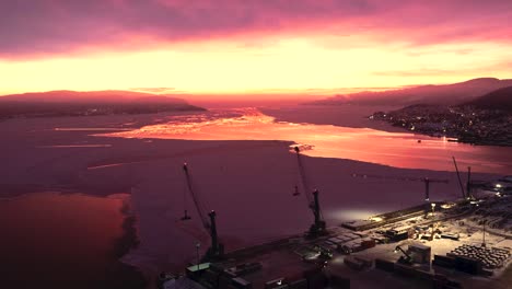Amazing-blood-red-sunrise-over-the-cranes-in-Drammen-harbor-during-the-winter