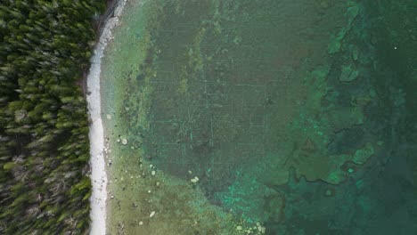 Bruce-peninsula,-Ontario,-Canada-in-early-spring-and-lake-Huron,-Drone-flies-up-revealing-underwater-mystery