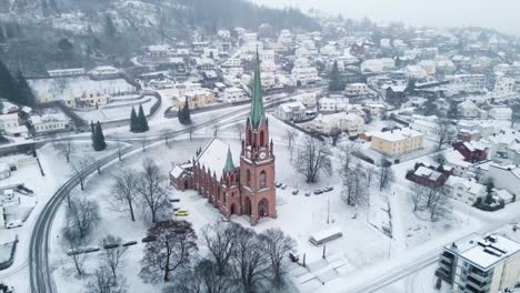 Panoramic-view-of-the-old-Bragernes-kirke-cathedral-in-the-center-of-Dramen-during-snowfall