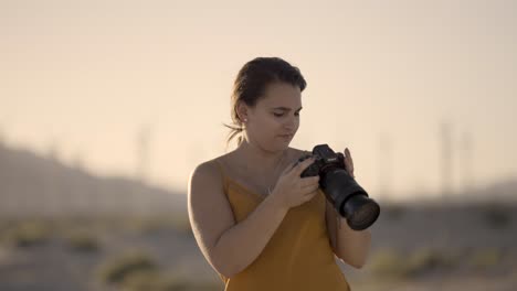 Girl-Photographing-Palm-Springs-area-desert-California-with-a-Sony-A1-camera-reviewing-photos