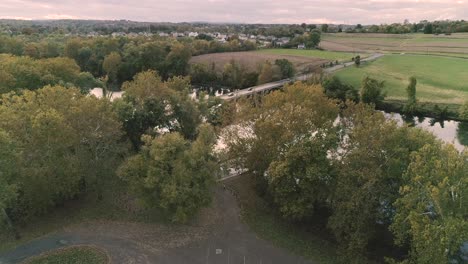 Phoenixville-Schuylkill-River-4k-Drone-in-Golden-Hour-during-Fall-Autumn-looking-across-at-the-farm-and-land
