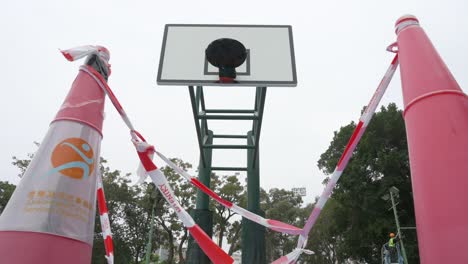 Low-angle-view-of-an-empty-colorful-basketball-court-is-seen-at-a-closed-playground-during-the-Covid-19-Coronavirus-outbreak-and-restrictions-in-Hong-Kong