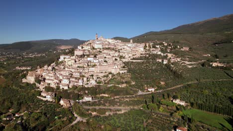 Aerial-view-of-a-medieval-town-of-Trevi-on-top-of-a-green-hill,-Italy