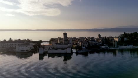 Aerial-view-Sirmione-italy,-peninsula-resort-town-on-lake-garda,-mediterranean-surroundings-historical-town-with-castle