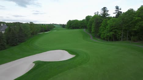 Golf-pitch-in-Aurora,-Ontario,-Canada-in-may,-flight-abave-the-ground